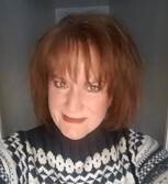 Luann Lieurance, SBA Lender Relations Specialist, smiling indoors in a patterned sweater, supporting Indiana’s small business community.
