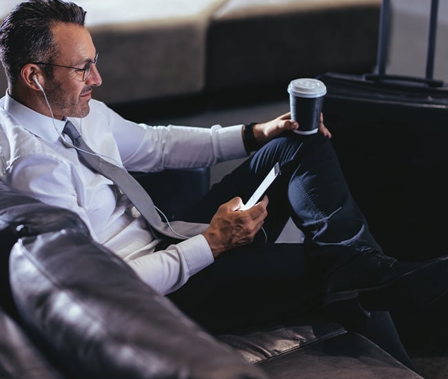 Businessman accessing his accounts at the airport