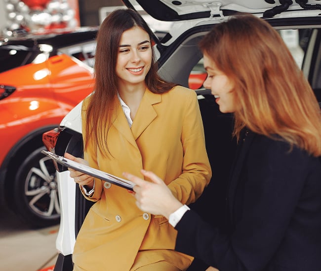 Dealer helping client buy a new car