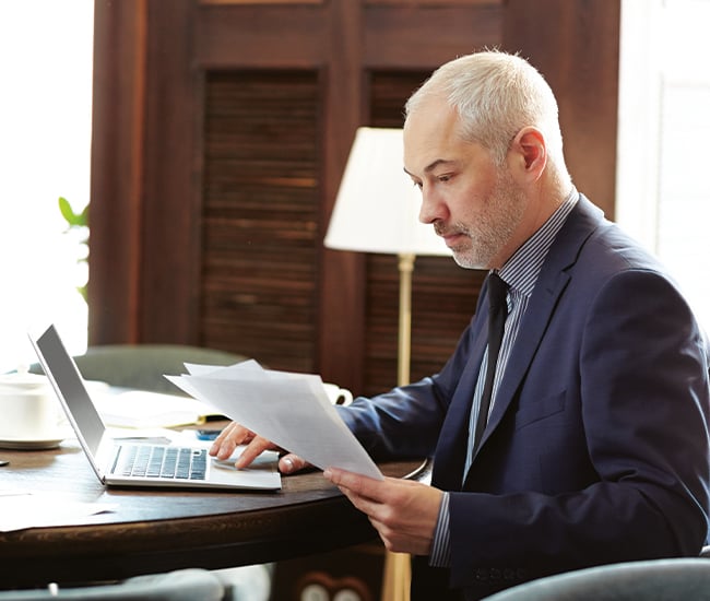 Mature Gentleman Reviewing Paperwork