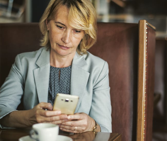 Woman monitoring accounts on her phone