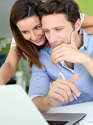 Couple Making Loan Payment on Computer