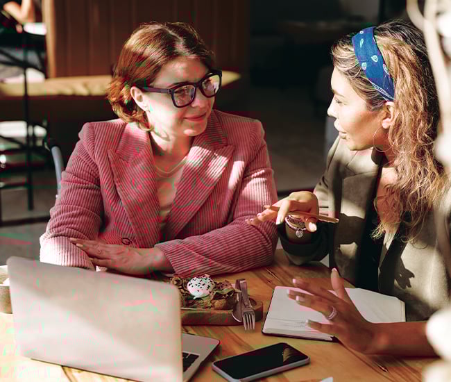 Two women working together to manage accounts