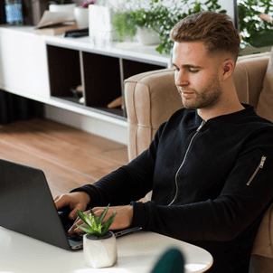 Young Man Opening Simply Free Checking Account on Laptop