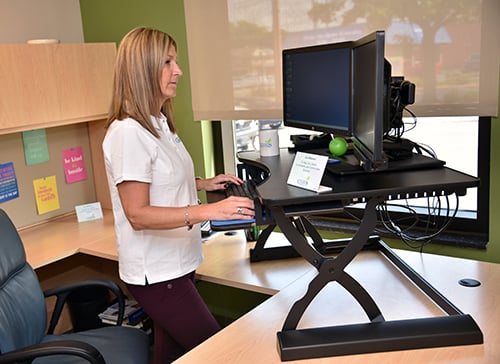 Employee using standing desk