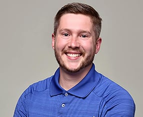 photograph of Ean Southerland wearing a blue shirt on a gray background
